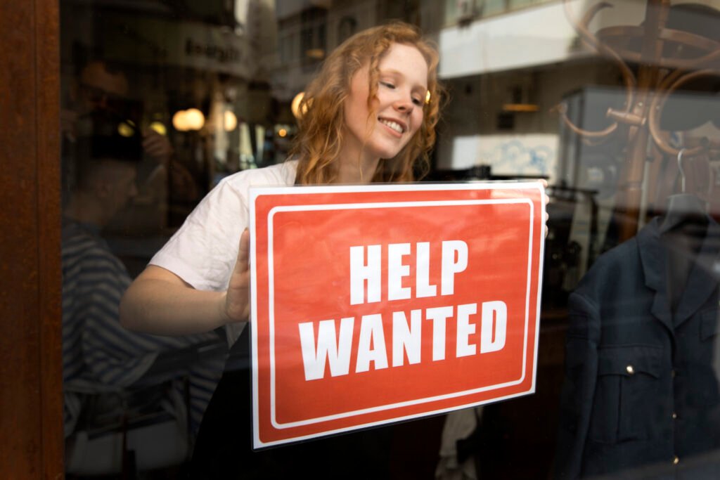 person-with-hiring-sign-by-window A0 poster