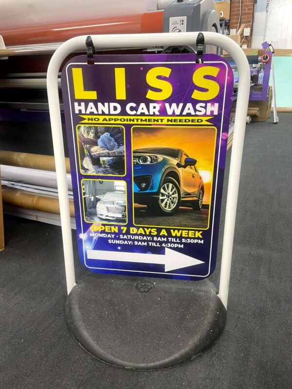 Double-sided outdoor pavement sign for car wash advertising, featuring a durable weather-resistant frame designed by Atlantic Design, used to display promotional messages and offers.