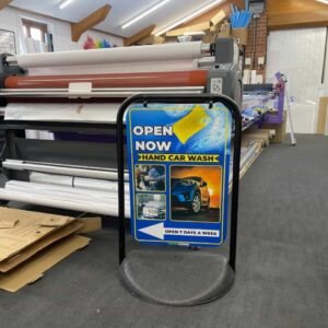 Double-sided outdoor pavement sign for car wash advertising, featuring a durable weather-resistant frame designed by Atlantic Design, used to display promotional messages and offers.